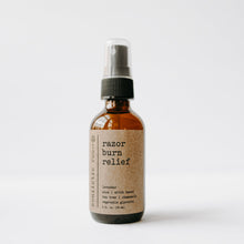 Load image into Gallery viewer, Razor burn relief after shave spray in a 2 oz glass amber bottle with a white background.