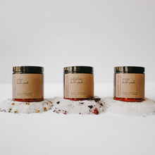 Load image into Gallery viewer, Herbal Epsom Bath Salts in amber jars. The bath salts are spilled out and there are eucalyptus leaves, chamomile flowers, lavender buds and rose petals
