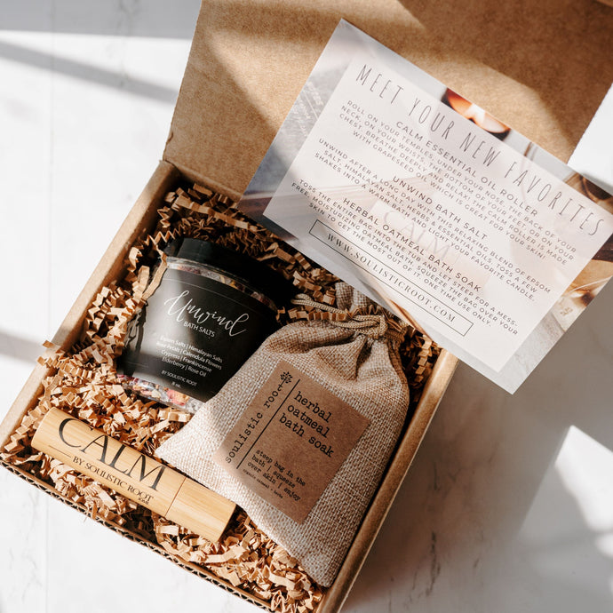 Gift box with 'Calm' product, small bag, and card on a marble surface