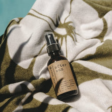 Load image into Gallery viewer, After Sun Aloe Vera Sunburn Spray 2 oz spray bottle on a green and white towel next to the pool
