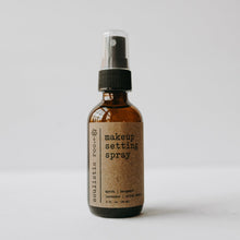 Load image into Gallery viewer, Makeup setting spray in a 2 oz amber glass bottle in front of a white background.
