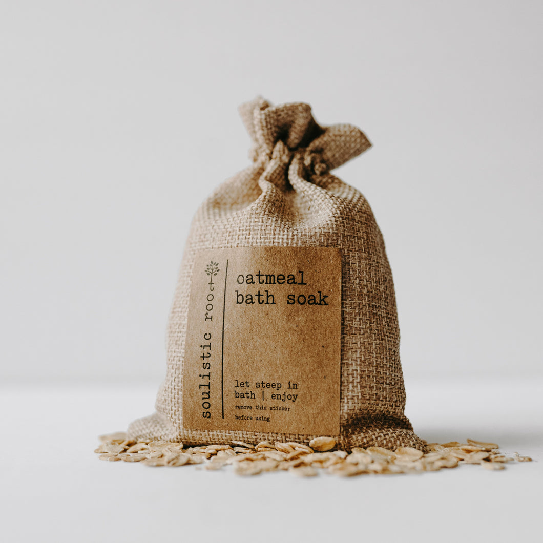 Herbal organic oatmeal bath soak in a burlap bag with some of the contents dumped out.