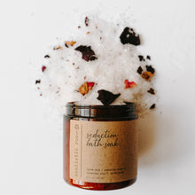 Load image into Gallery viewer, Herbal epsom salt bath in an amber jar. It is the seduction blend with rose petals and salt dumped out
